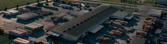 Aerial view of a warehouse with pallets stacked outside