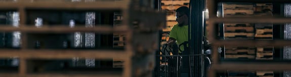 Man on a forklift retrieving pallets