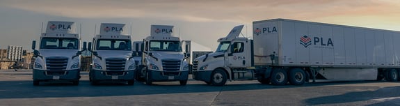 Fleet of PLA trucks parked outside